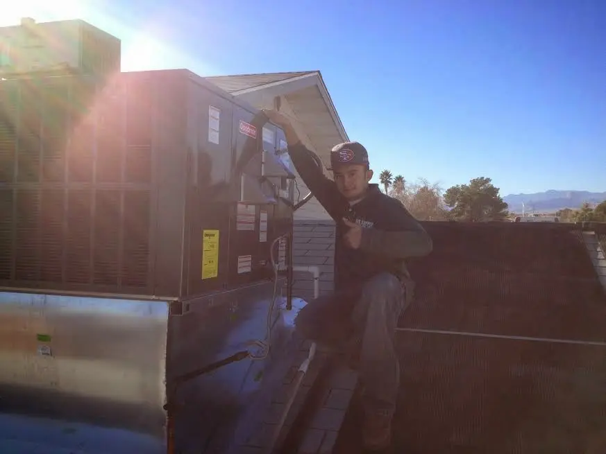 HVAC technician performing HVAC Inspection on a rooftop unit in Van Buren